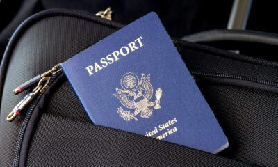 Bolsa preta com um passaporte norte americano aparecendo no bolso externo.